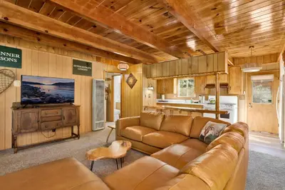 a living room with a couch and a kitchen at Slope Side Getaway #2526 in Big Bear Lake