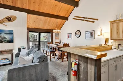 a kitchen and living room with a couch and a table at Switzerland Summit Condo #2569 in Big Bear Lake