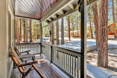 a wooden porch with a rocking chair on it at Golden West Cottage #2581 in Big Bear Lake
