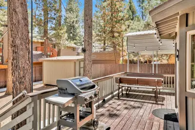 a grill and a bench on a deck at Golden West Cottage #2581 in Big Bear Lake