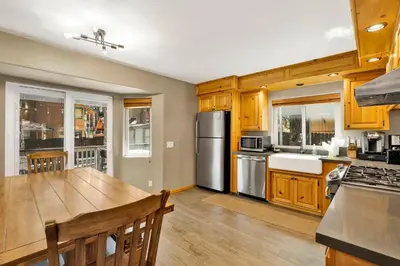 a kitchen with wooden cabinets and a wooden table at Golden West Cottage #2581 in Big Bear Lake