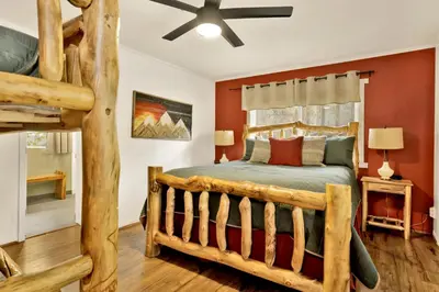 a bedroom with a wooden bed in a room at Arlberg Village Haus #2571 in Big Bear Lake