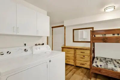 a kitchen with white cabinets and a white dishwasher at Arlberg Village Haus #2571 in Big Bear Lake