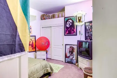 a room with a bed and a tv and pictures on the walls at 5 Mi to the Marketplace Roomy Bakersfield Retreat in Bakersfield