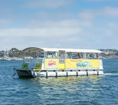 a yellow and white water bus on the water at Waterfront Penthouse - Marina Views - Rooftop in Los Angeles