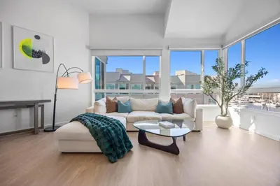 a living room with a couch and a table at Waterfront Penthouse - Marina Views - Rooftop in Los Angeles
