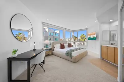 a bedroom with a bed and a desk and a mirror at Waterfront Penthouse - Marina Views - Rooftop in Los Angeles