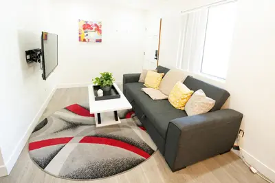 a living room with a couch and a rug at Cozy 2 Bedroom In Hollwood area Close to Downtown La in Los Angeles