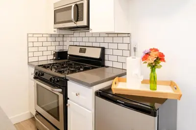 a kitchen with a stove and a vase of flowers at Cozy 2 Bedroom In Hollwood area Close to Downtown La in Los Angeles