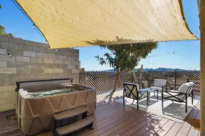 a hot tub on a deck with a table and chairs at Darling 2 bedroom 1 bathroom Highland Park Home with Jacuzzi and View in Los Angeles