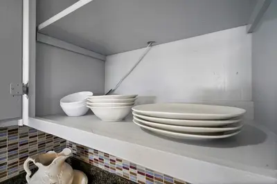 a shelf with white bowls and plates on it at Darling 2 bedroom 1 bathroom Highland Park Home with Jacuzzi and View in Los Angeles
