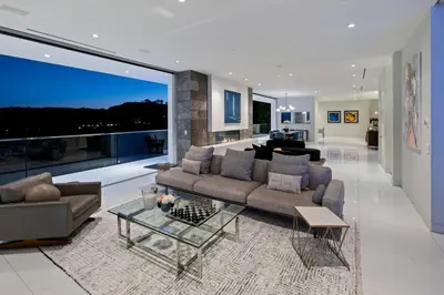 a living room with a couch and a table at Stunning Hollywood Villa Pool and Panoramic Views in Los Angeles