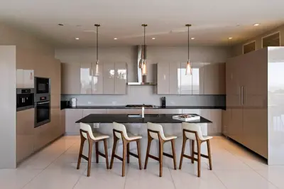 a kitchen with a table and some stools at Stunning Hollywood Villa Pool and Panoramic Views in Los Angeles