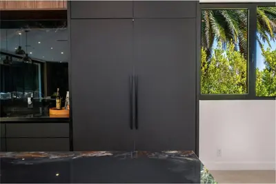 a black cabinet in a kitchen with a window at Luxury 6BR Beverly Hills Villa with Pool and Views in Los Angeles