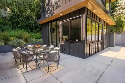 a patio with a table and chairs and a building at Luxury 6BR Beverly Hills Villa with Pool and Views in Los Angeles