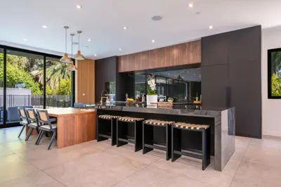 a kitchen with a bar and a dining room at Luxury 6BR Beverly Hills Villa with Pool and Views in Los Angeles