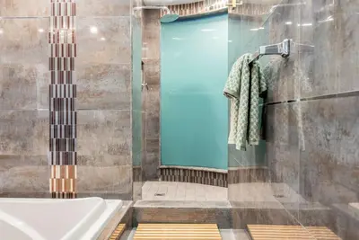 a shower with a blue door in a bathroom at Ocean-View 1BR Condo in Historic Cooper Arms in Long Beach