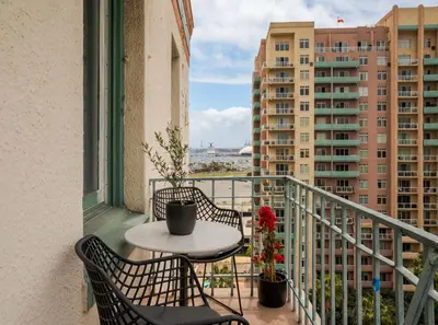 a balcony with a table and chairs and buildings at Ocean-View 1BR Condo in Historic Cooper Arms in Long Beach