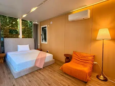 a bedroom with a bed and a lamp and a chair at Serene Glasshouse Retreat with Iconic LA Skyline Views in Los Angeles