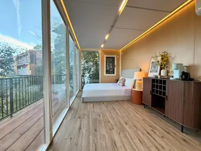 a bedroom with a bed and a balcony at Hollywood Hills Glass Cabin-Skyline view -Floor to Ceiling Windows in Los Angeles