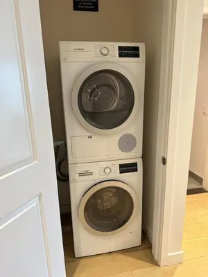 two washing machines and a washer and dryer in a room at DTLA Luxury Studio in Los Angeles