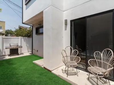 a patio with lawn chairs and a piano on a balcony at Luxury Modern 4 Bed 4 Bath Home with Rooftop Deck #6 in Los Angeles