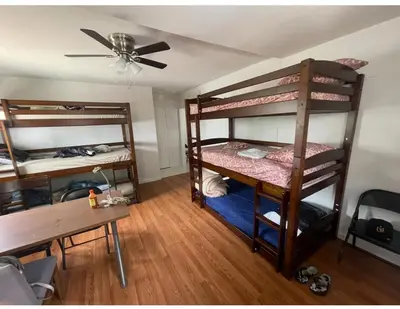 a room with two bunk beds and a table at Bunk beds in Los Angeles