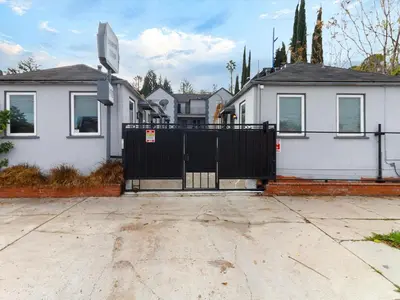a black gate in front of a house at Cozy Studio, Studio City Unit 2 in Los Angeles