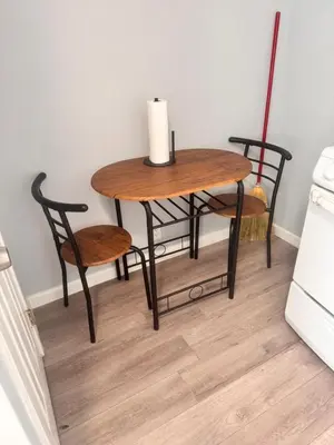 a wooden table and two chairs and a table with a candle at Cozy Studio, Studio City Unit 2 in Los Angeles