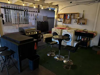 a room with a washing machine and stools at Cozy Private Room Near Disneyland, Beaches & Downtown LA in Artesia