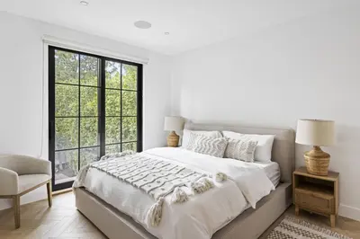 a white bedroom with a large bed and a window at One of Kind Ultra Luxury Beverly Hills Estate in Los Angeles