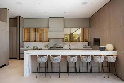 a kitchen with a large island with bar stools at Ultra-Luxurious BH Estate with Pool, Theatre, Views in Beverly Hills