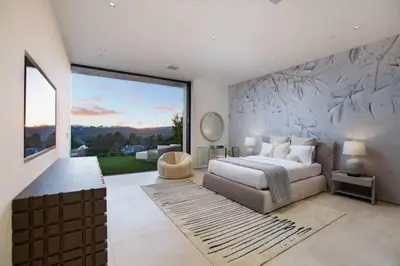 a bedroom with a bed and a large window at Ultra-Luxurious BH Estate with Pool, Theatre, Views in Beverly Hills