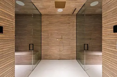 a bathroom with a shower with glass doors at Luxurious 5BR Villa in BH with Pool, Theater, and Views in Los Angeles