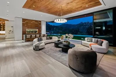 a living room filled with furniture and a large window at Luxurious 5BR Villa in BH with Pool, Theater, and Views in Los Angeles