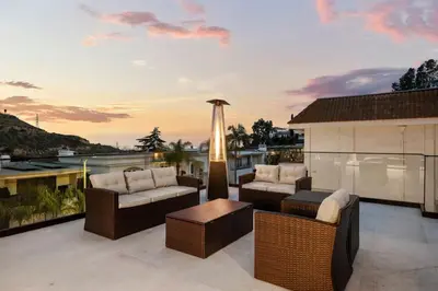 a patio with furniture and a view of the water at Luxury Jupiter Estate with 4BR with Pool and Jacuzzi in Los Angeles
