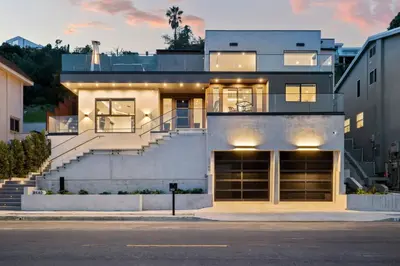 a house with a staircase in front of a building at Luxury Jupiter Estate with 4BR with Pool and Jacuzzi in Los Angeles