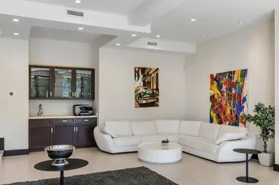 a living room with a white couch and a table at Summitridge Bev Hills Villa with Pool, Spa, Roof Deck in Beverly Hills