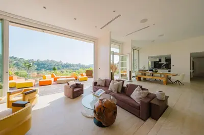 a large living room with couches and a large window at Beverly Hills Ultra Luxury Villa with Pool and Theatre in Beverly Hills