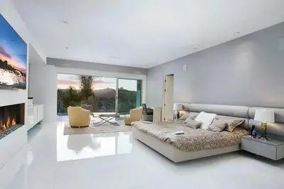 a bedroom with a large bed and a fireplace at Beverly Hills Mansion W. Stunning Views in Beverly Hills