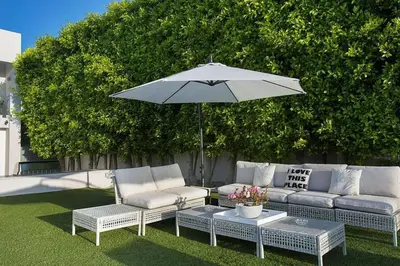 a patio with two couches and an umbrella at Beverly Hills Mansion W. Stunning Views in Beverly Hills