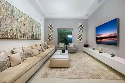 a living room with a large couch and a large painting at Beverly Hills Mansion W. Stunning Views in Beverly Hills