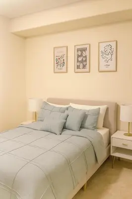 a bedroom with a large white bed with two lamps at Holiday in LA- Koreatown Retreat with Free Parking, Pool and Sauna in Los Angeles