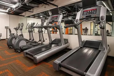 a gym with several treadmills and cardio machines at Holiday in LA- Koreatown Retreat with Free Parking, Pool and Sauna in Los Angeles