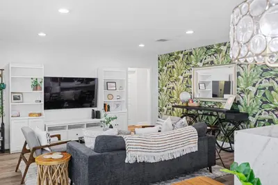 a living room with a couch and a tv at Pool House Retreat near LAX, SoFi & Beach in Inglewood