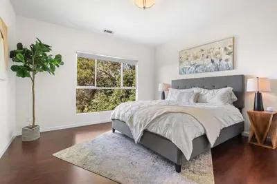 a bedroom with a large bed and a window at LA Chic Stunning Views & Sunsets in Los Angeles