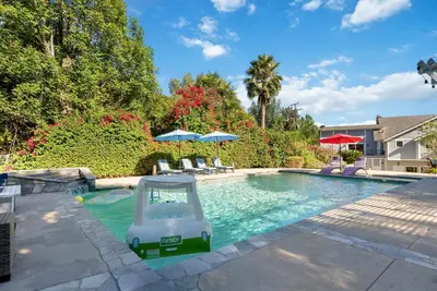 a swimming pool with a swing in a yard at Luxury LA Garden Estate Private Pool HotTub Tennis in La Habra