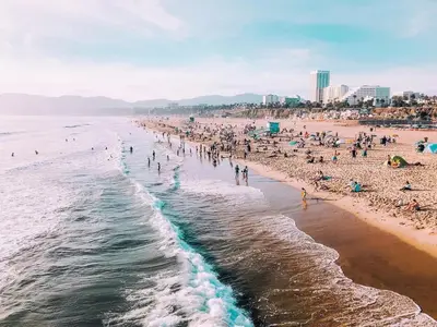 a crowded beach with a lot of people on it at Charming Modern apartment in Santa Monica in Los Angeles