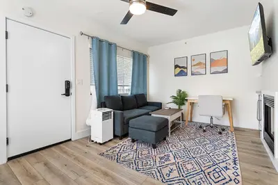 a living room with a couch and a table at Charming Modern apartment in Santa Monica in Los Angeles