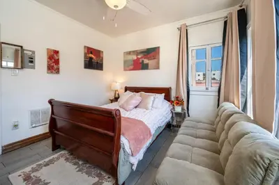 a bedroom with a bed and a couch at Sleek Studio Near Downtown LA • AC • WiFi • Snacks in Los Angeles